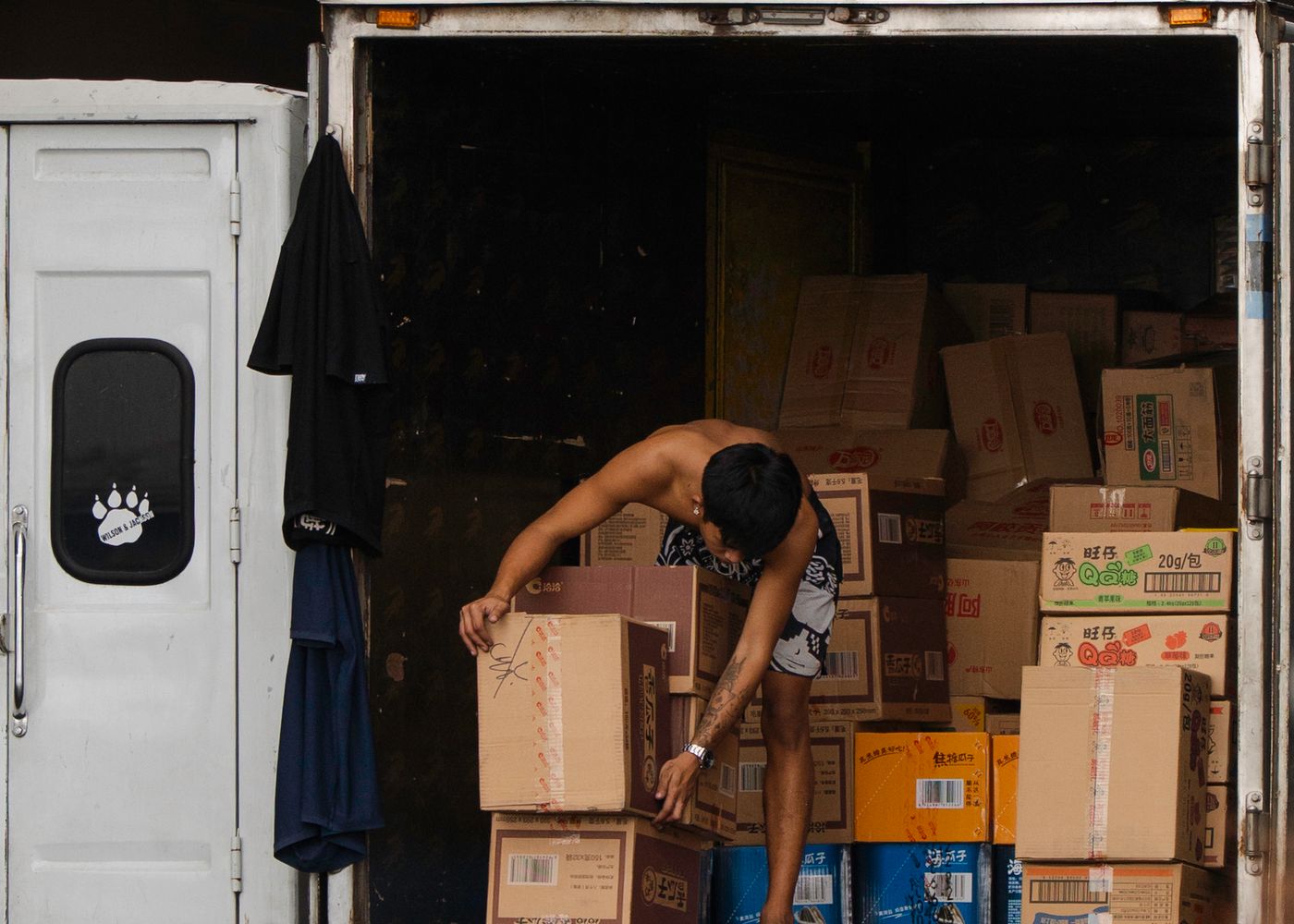 Cargo truck configuration: loading cargo into a truck. Illustrative stock photo.